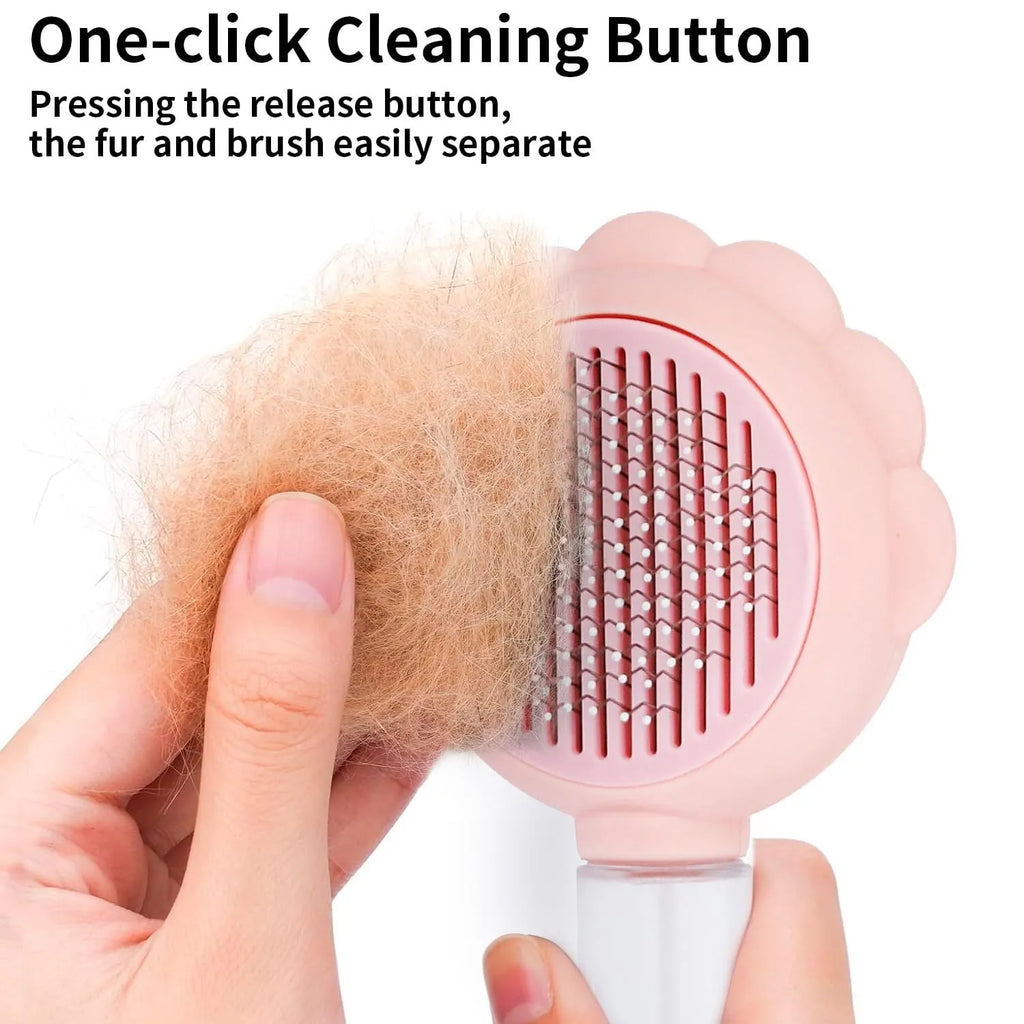 Grey spray cat grooming brush with self-cleaning button and curved stainless steel bristles on a white background.