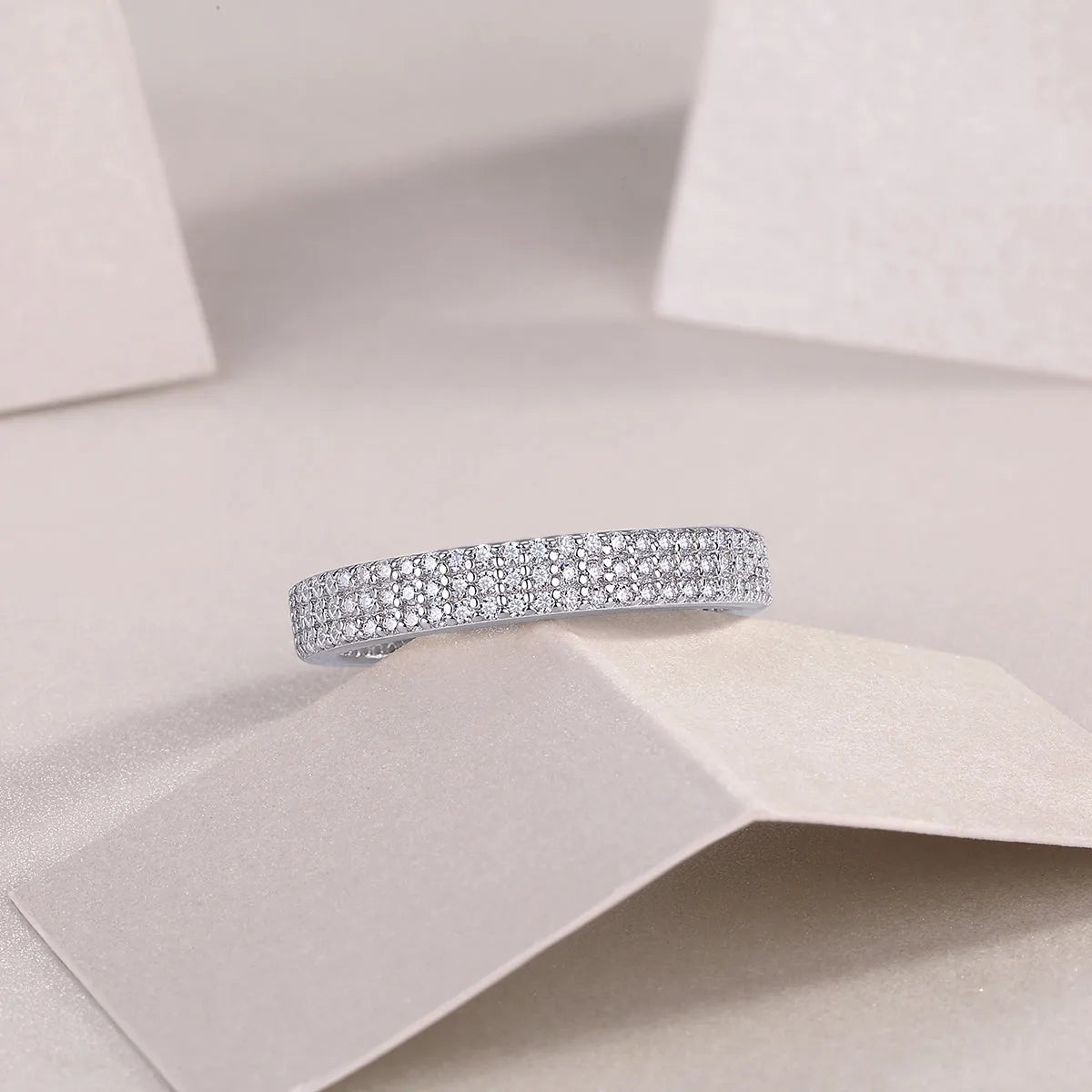 Moissanite wedding ring set in S925 silver with platinum plating, yellow gold colour, on white background