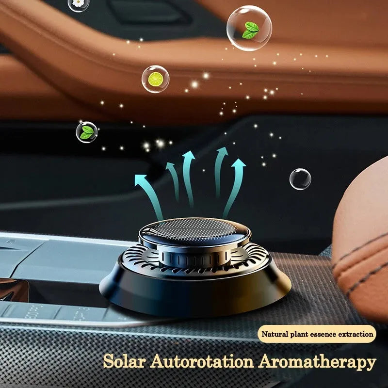 Solar-powered kinetic car air freshener with double rotating rings and plastic housing