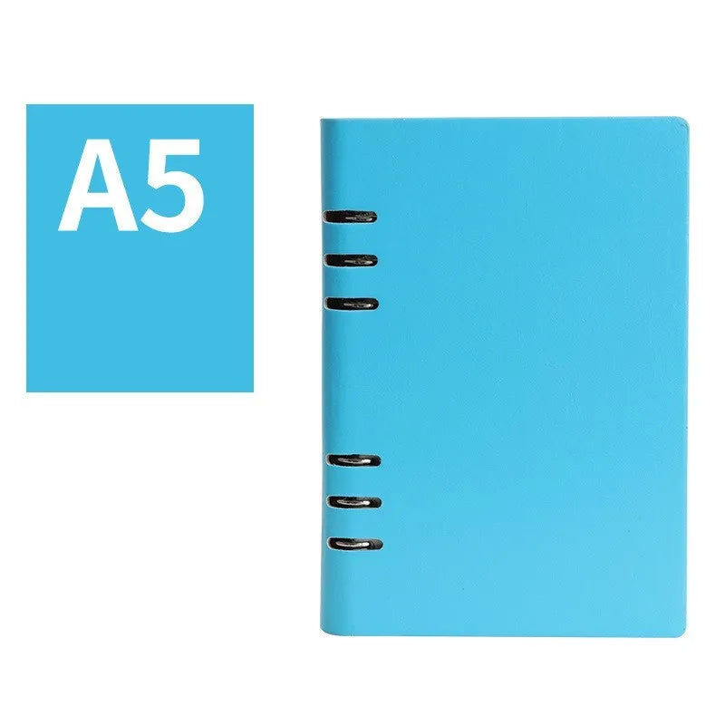Loose-leaf business notebook with imitation leather cover in multiple colours, open to show beige paper.