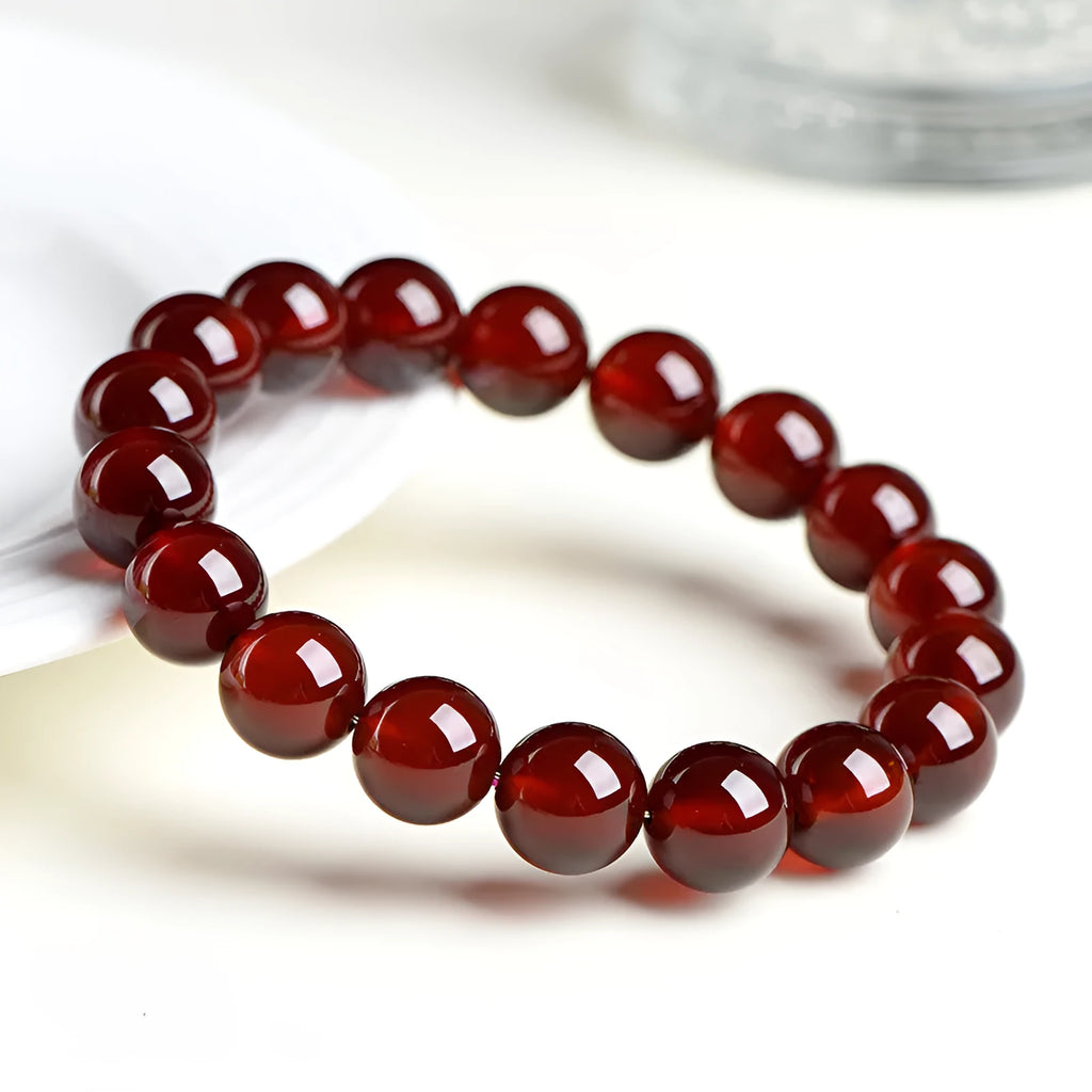 Natural orange red garnet ball crystal bracelet with Ruyi design in retro unisex style.
