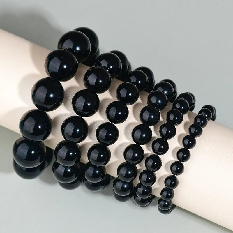 Hand-woven ethnic style unisex obsidian bracelet with round crystal beads.