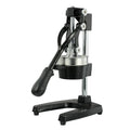 Tall black cast iron manual citrus juicer with stainless steel strainer on a kitchen counter.