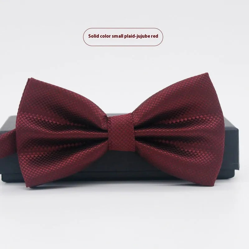 Men's flat head style polyester bow tie in a solid colour, shown with adjustable neck strap.