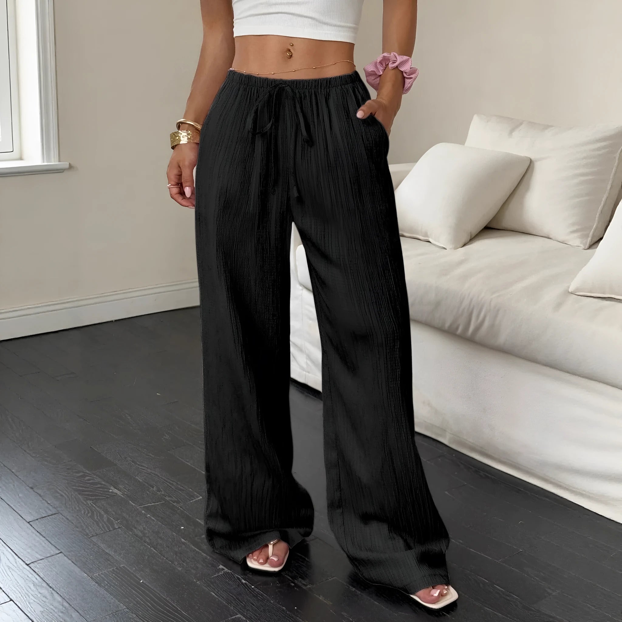 Women's black wide-leg trousers with lace-up waist detailing and adjustable ties