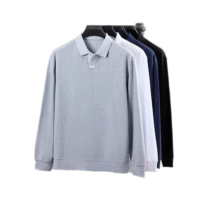 Man wearing a loose grey cotton polo shirt with a lapel collar and asymmetric design detail.