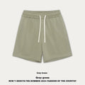 Baby boy and girl wearing loose-fitting cotton denim shorts in cream apricot colour.