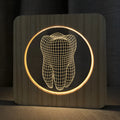 Wood colour tooth-shaped acrylic night light with USB cable on a table