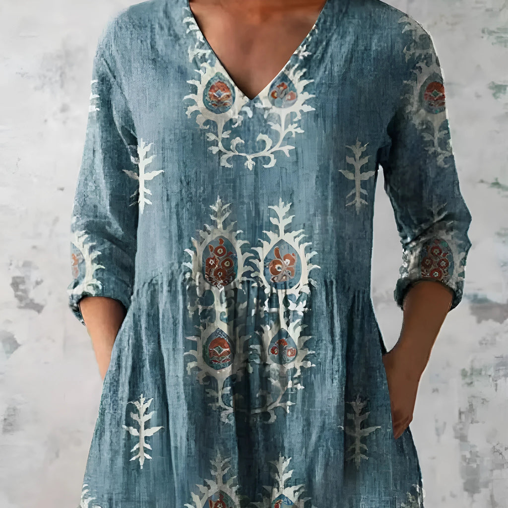 Women's long loose dress with a blue and white wave print pattern, featuring three-quarter sleeves and a wide waist.