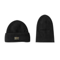 Vintage knitted melon skin warm beanie in black with patch detail on a plain background