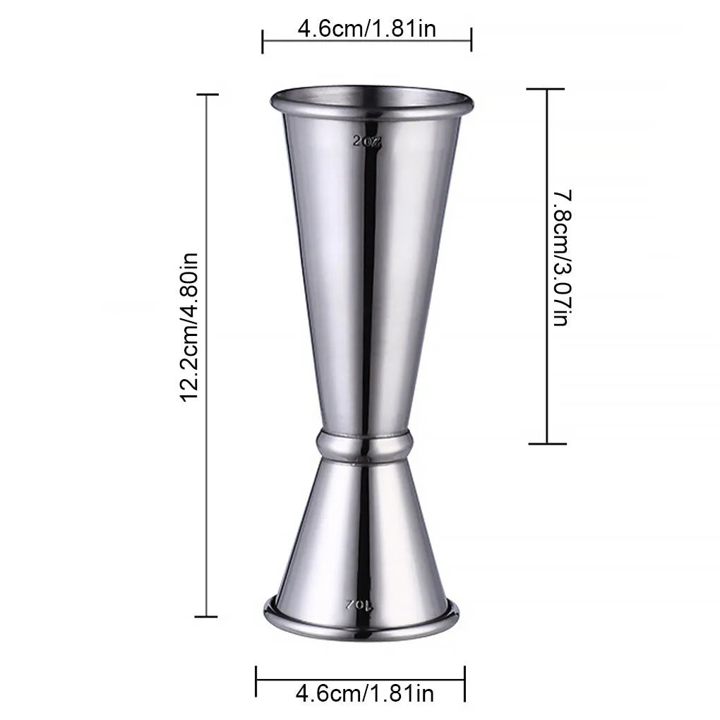 Double-headed stainless steel measuring cup and shaker on a bar counter for cocktail preparation