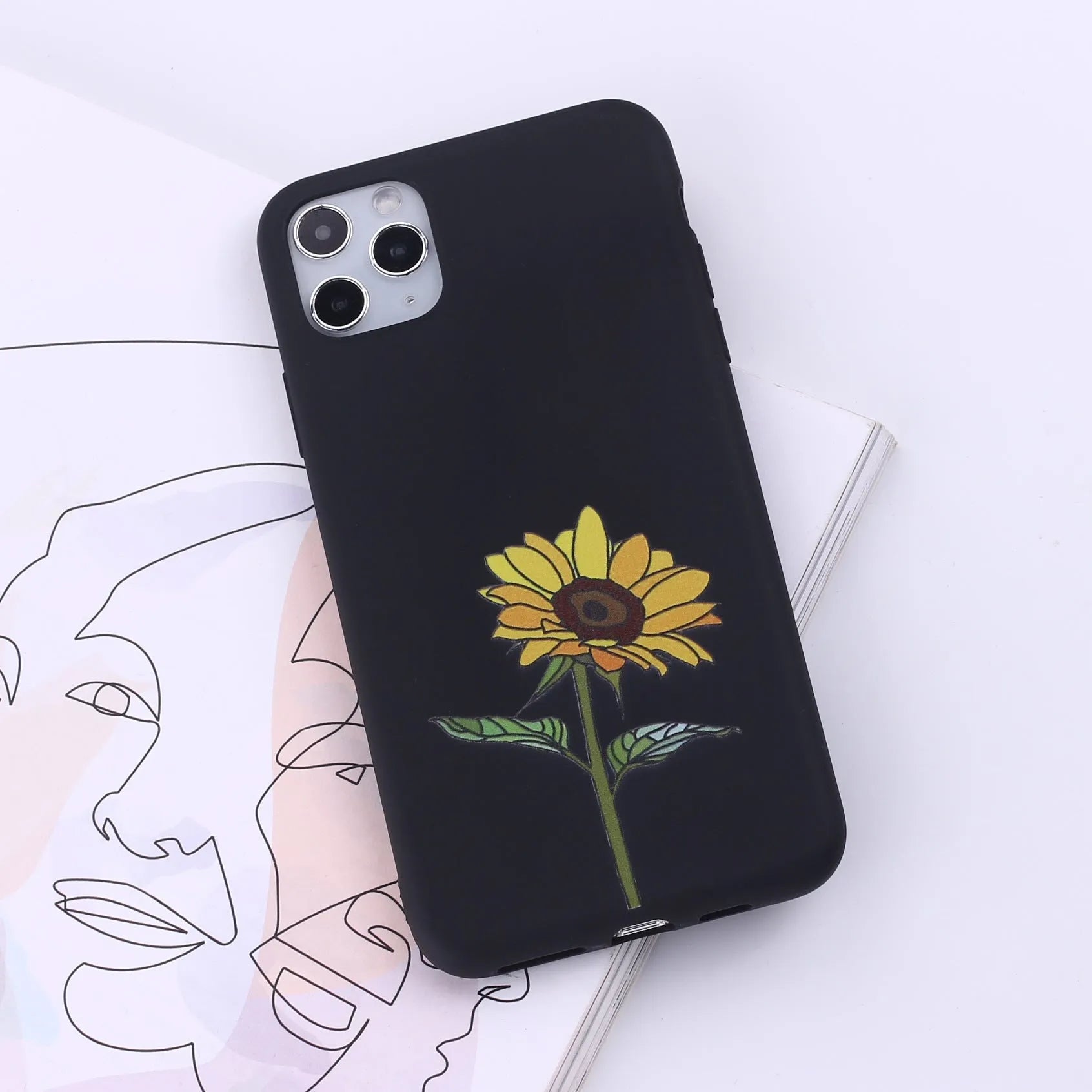 Slim TPU mobile phone case for iPhone on a table, showing one of 14 available colour options.