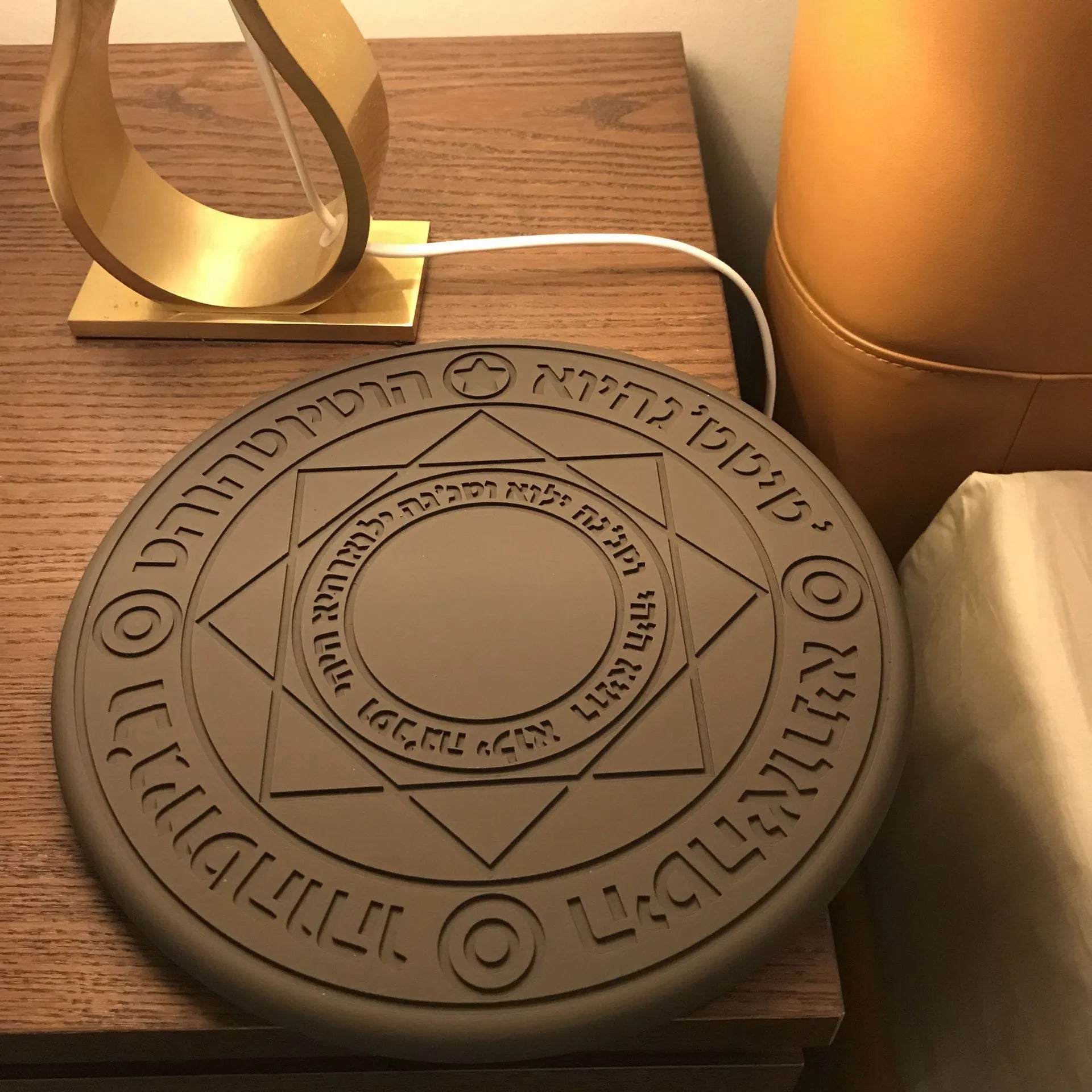 Square wireless phone charger with glowing magic array pattern showing 10W fast charging