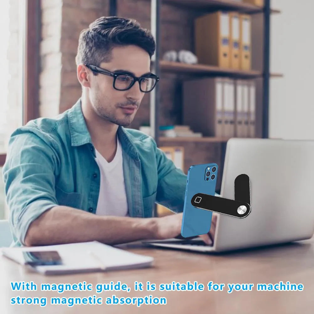 Black magnetic laptop phone holder with foldable aluminium bracket attached to a laptop screen