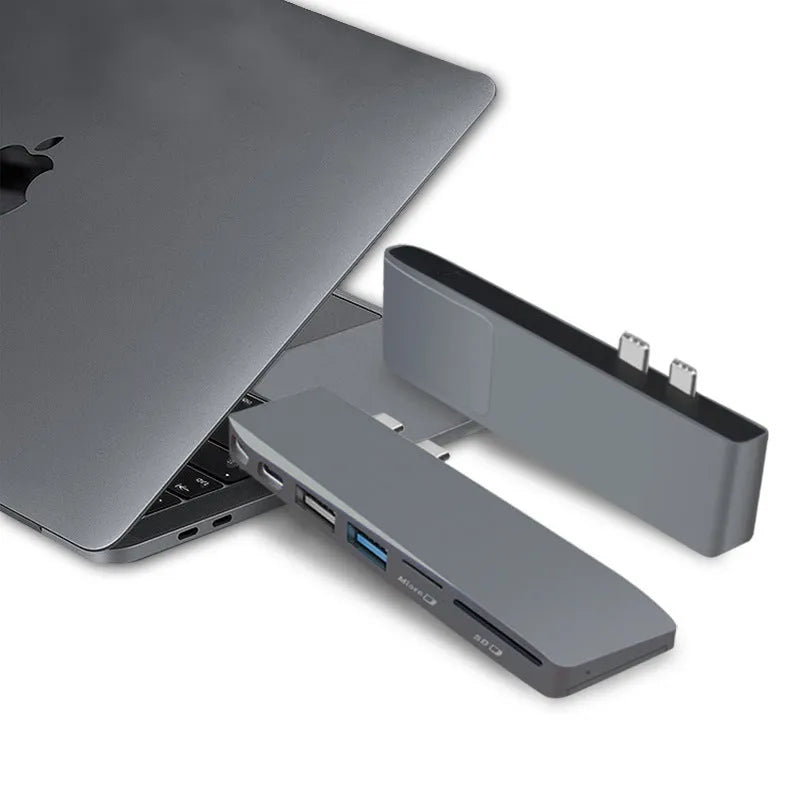 Silver 8-in-1 USB-C hub for MacBook Pro with multiple ports including USB 3.0, HDMI, and card slots