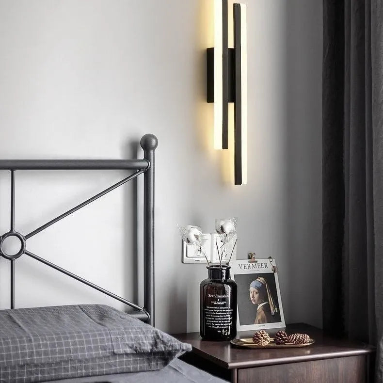 Modern Scandinavian minimalist LED wall light with acrylic shade in black or gold finish.