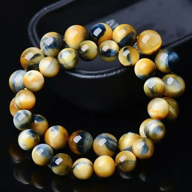 Fantasy Tiger Eye agate beaded bracelet with round beads, shown in unisex design.