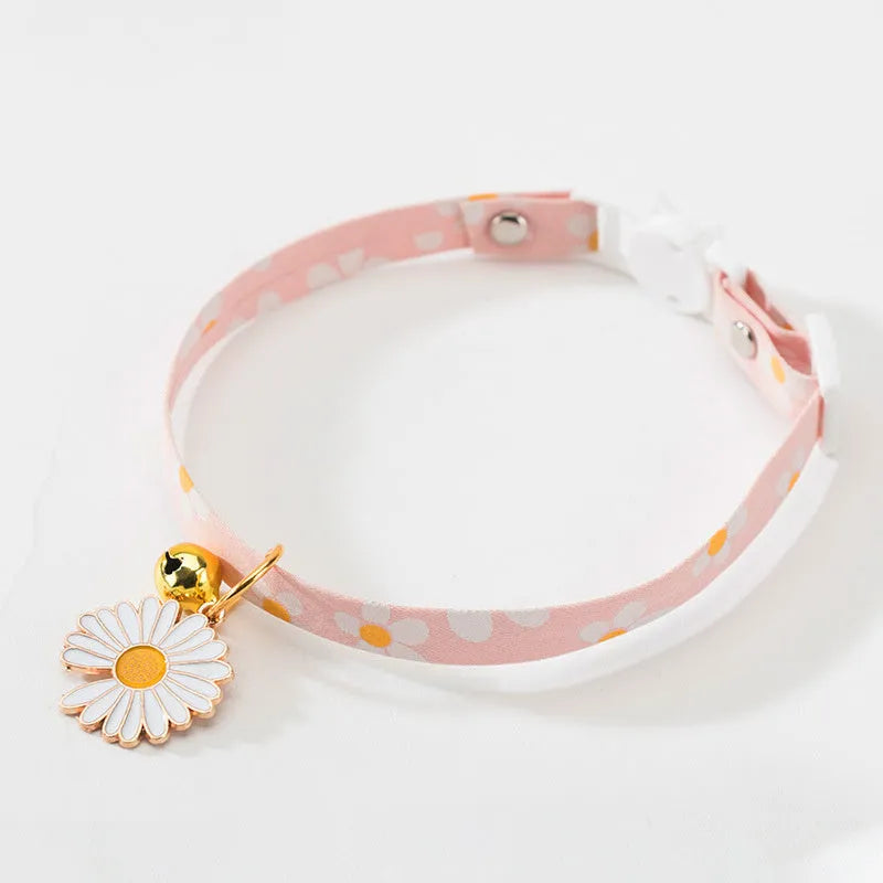 Adjustable green cat collar with a metal bell and a matching bow tie for small pets.