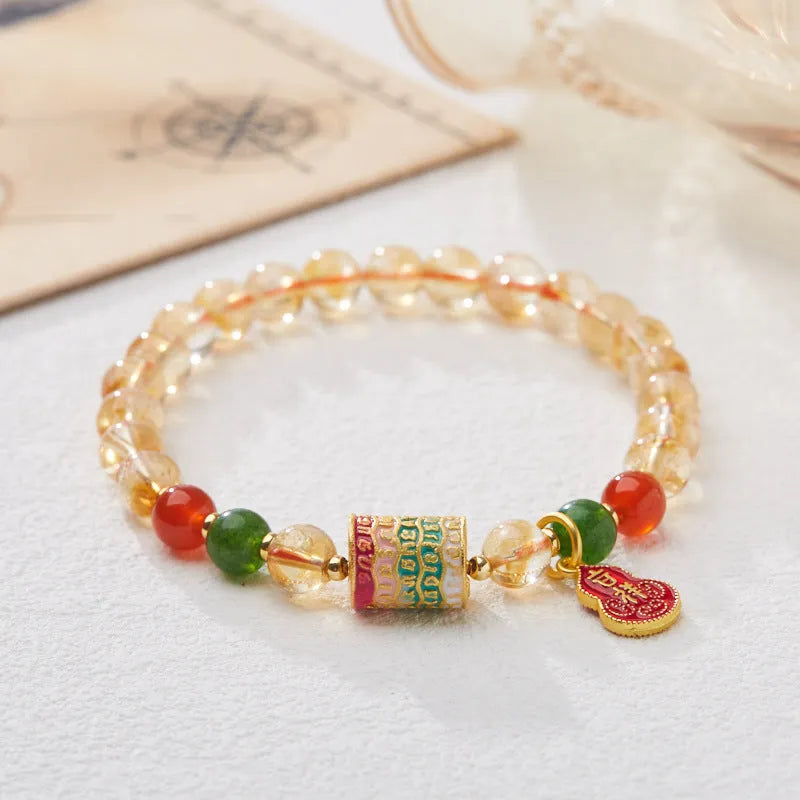 Hand-woven citrine crystal bracelet with five-sutra geometric pattern showing 6mm bead size