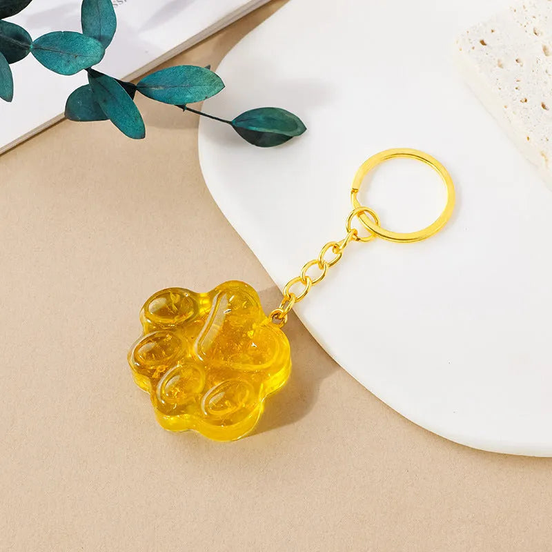Natural crystal cat's paw keychain pendant in assorted gemstone colours on a keyring.