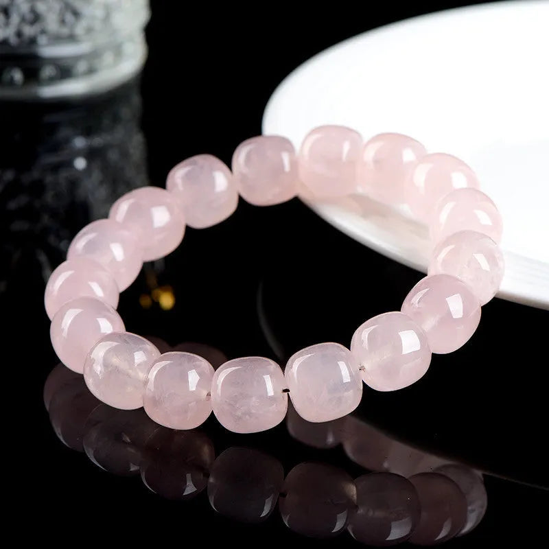 Pink crystal barrel bead bracelet with 11mm to 12mm geometric beads on natural background