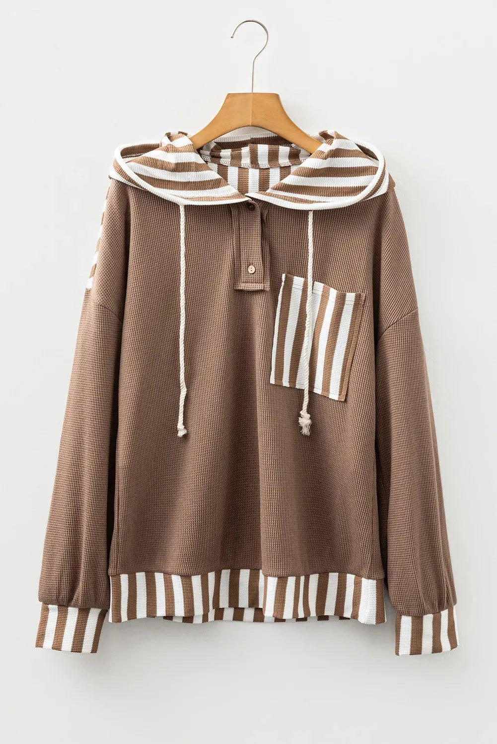 Straw yellow hoodie with waffle texture and striped patchwork design, featuring a button neck and drawstring hood.