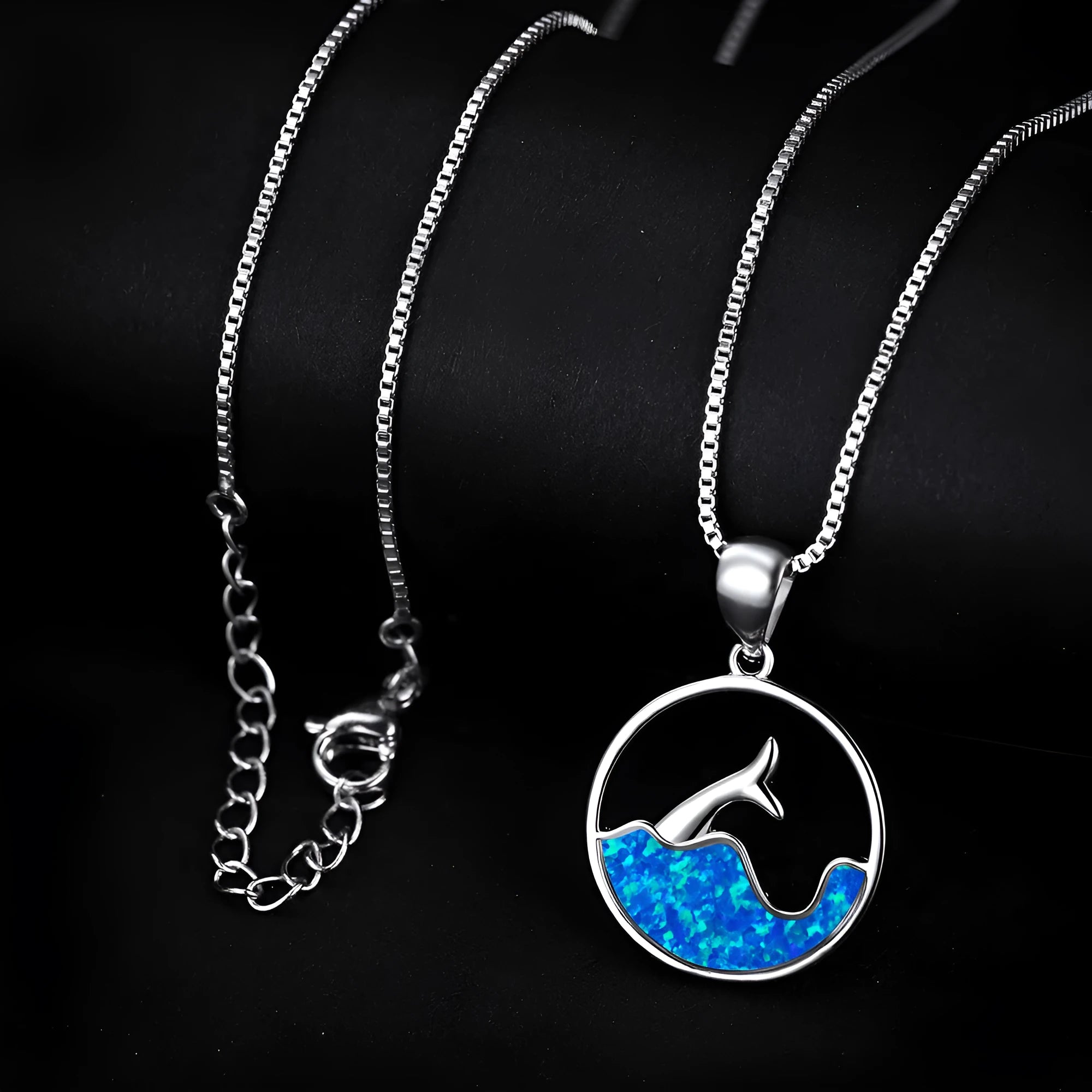 Geometric round fishtail pendant necklace with a blue opal stone on a chain, showing white gold electroplated finish.