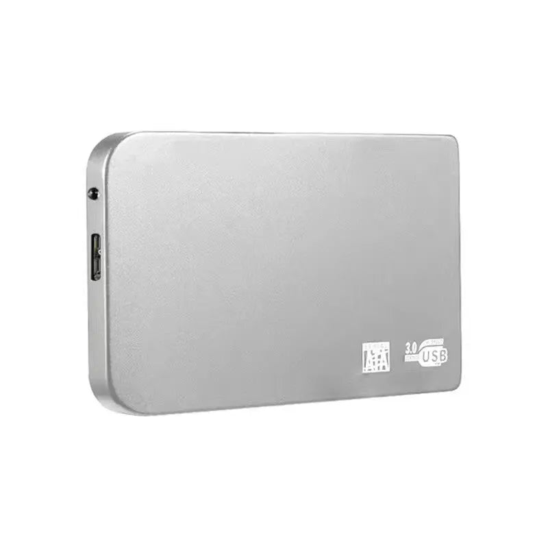 Silver metal external solid state drive with USB cable and cover next to packaging.