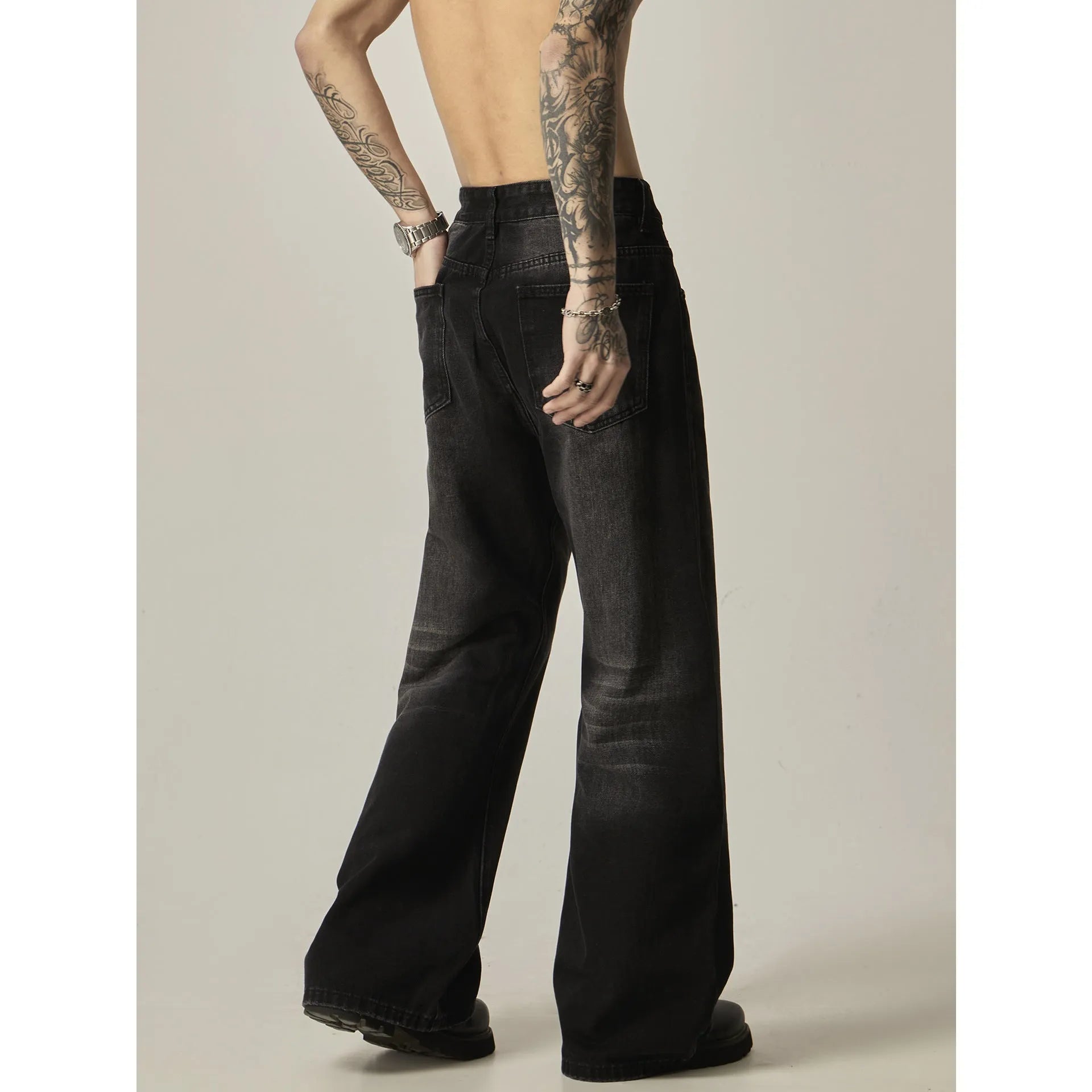 Black straight leg jeans with loose retro styling and basic zip fly design