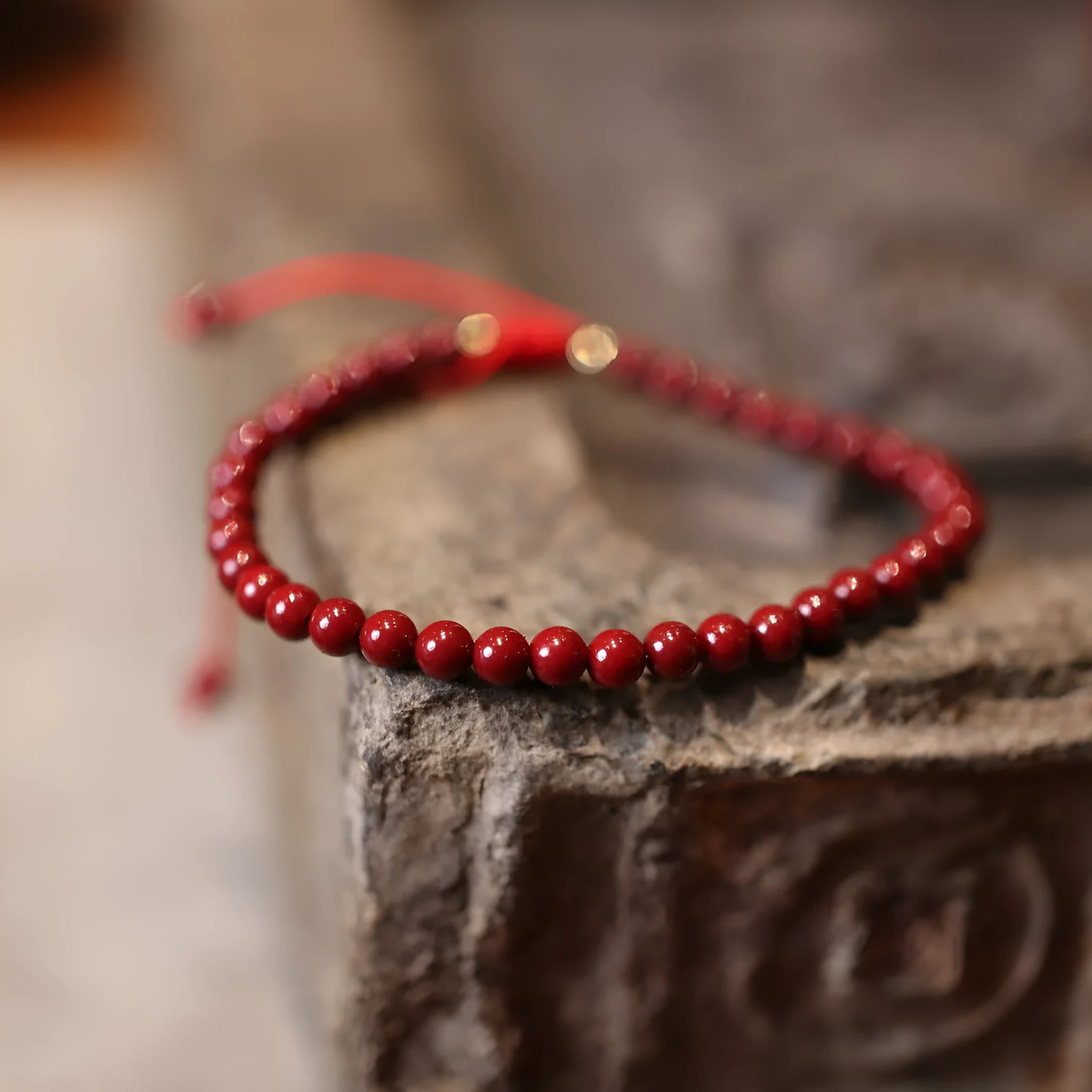 Close-up of a purple gold sand cinnabar bracelet with geometric shapes and auspicious patterns.