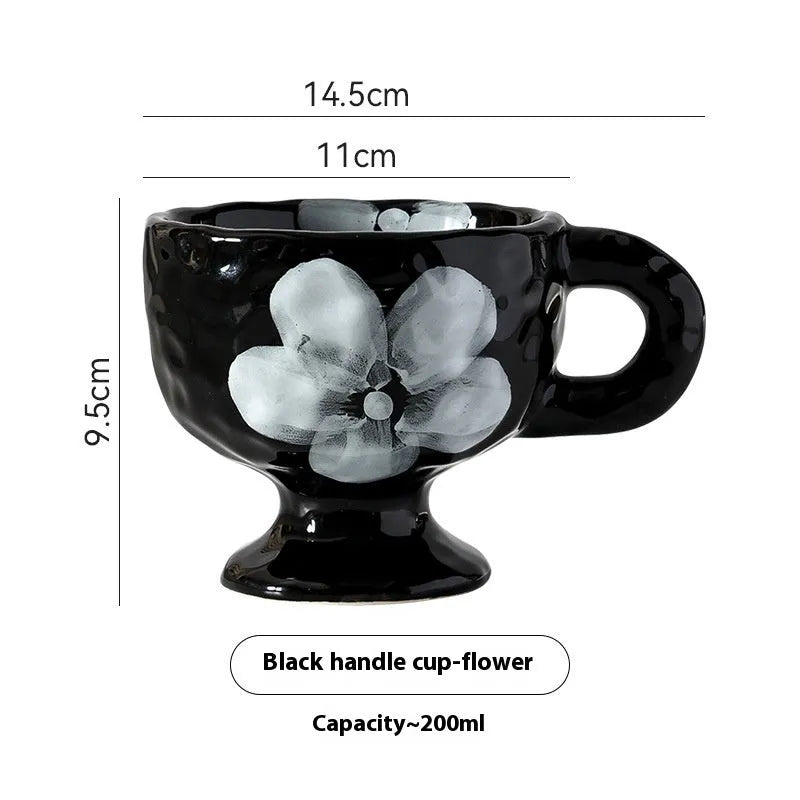 Hand-pinched irregular shaped ceramic mug in a solid colour on a table.
