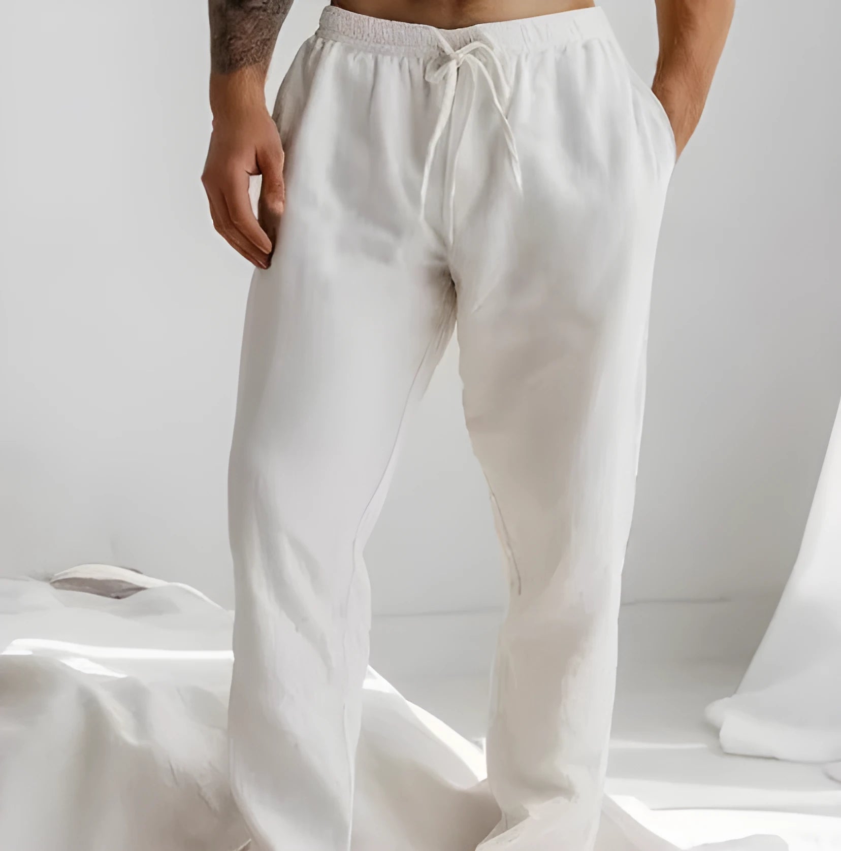 Men's light grey loose-fit summer trousers with elastic waistband and straight leg opening