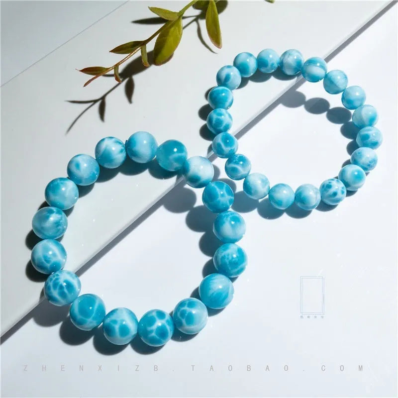 Blue and natural toned handmade bodhi bracelet with sea-pattern stones and pearl elements
