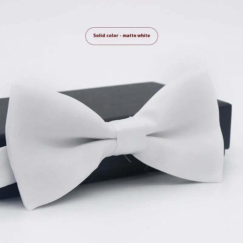 Men's flat head style polyester bow tie in a solid colour, shown with adjustable neck strap.