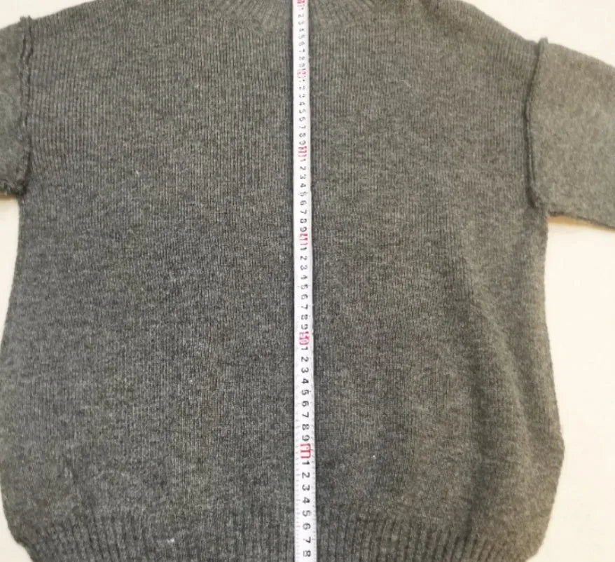 Women's dark grey acrylic sweater with side slits paired with matching trousers