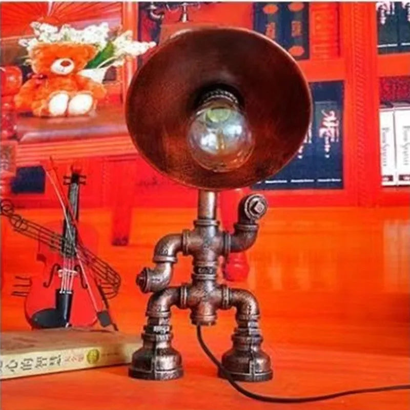 Industrial vintage table lamp shaped like a robot made from iron water pipes in a retro colour.