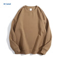 A loose-fitting, off-shoulder cotton sweater in a solid colour with long sleeves and a round neck.