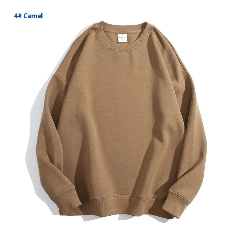 A loose-fitting, off-shoulder cotton sweater in a solid colour with long sleeves and a round neck.