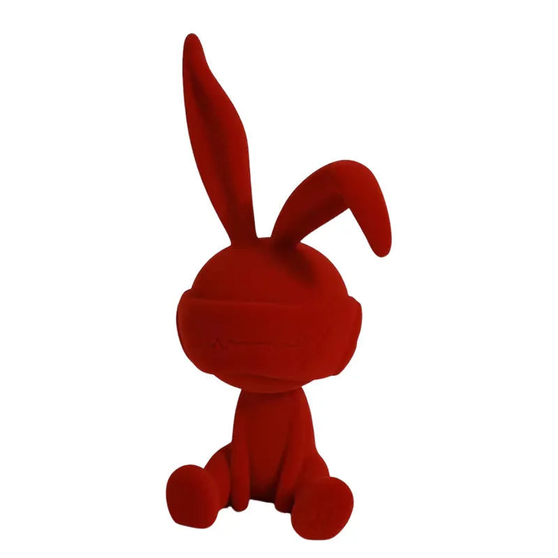 Suede blindfold rabbit resin table ornament in chosen colour on a wooden surface.