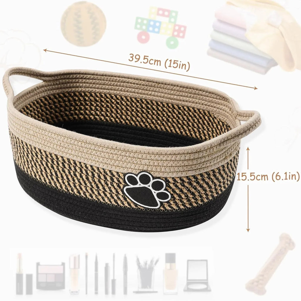 Light beige handmade woven cotton rope storage basket with wooden base and handle on a table.
