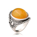 Geometric alloy ring with antique silver amber electroplated finish on a grey background.