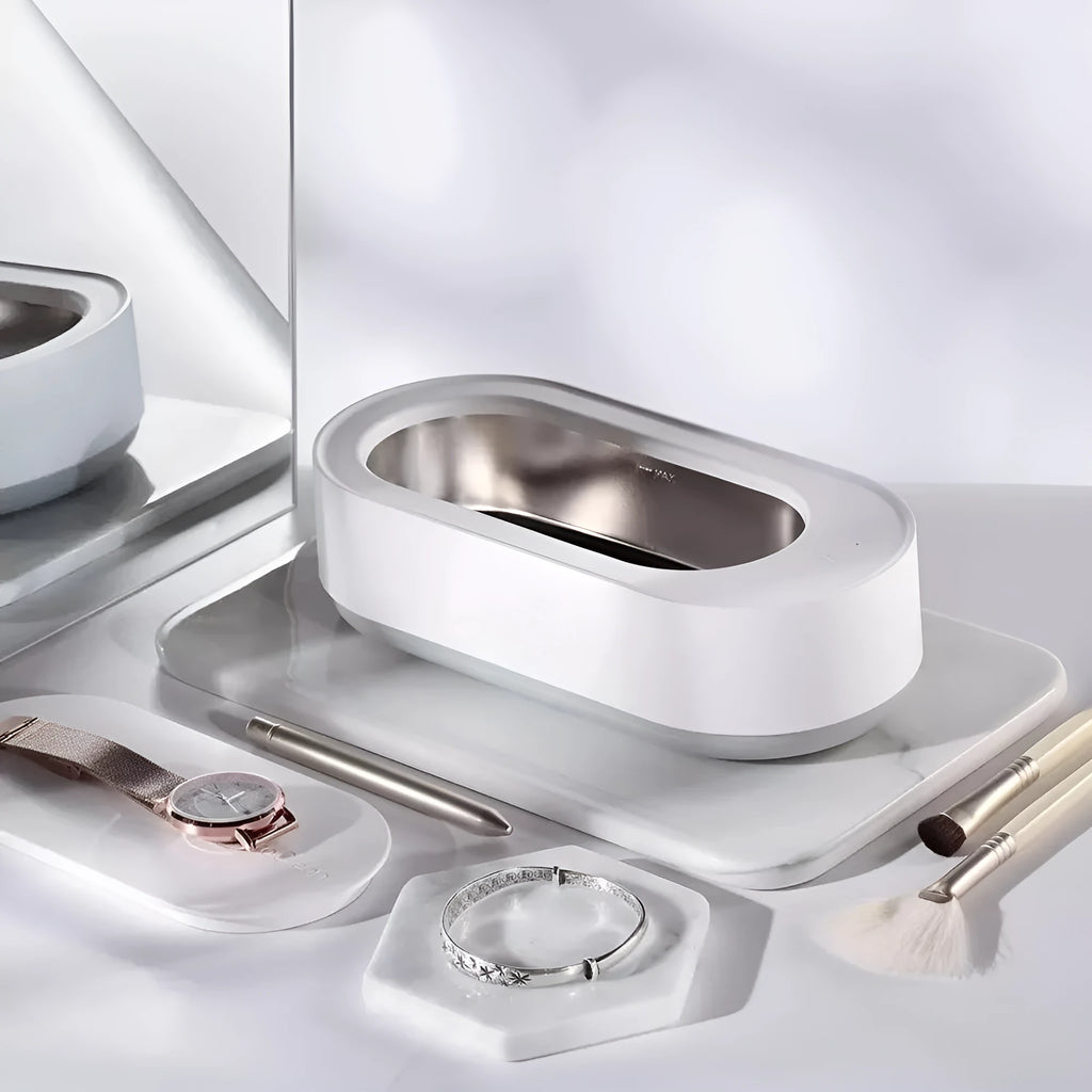 White portable ultrasonic cleaning machine with a stainless steel tank for jewellery and glasses.