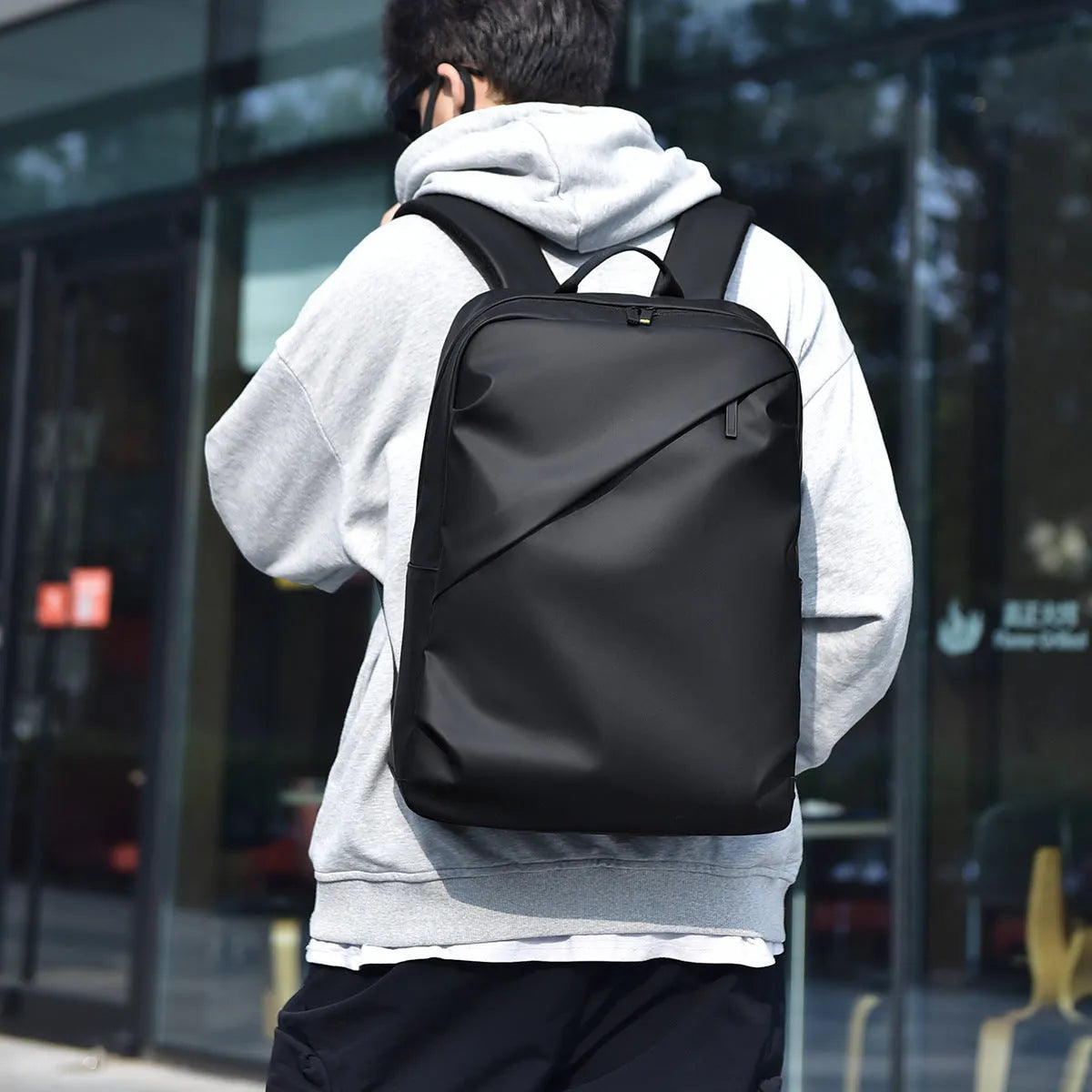 Large capacity waterproof backpack in black blue or grey colours made from PU leather with simple design