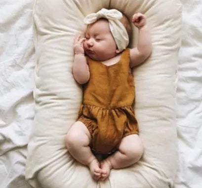 Beige portable cotton baby nest crib cushion measuring 75cm by 45cm for infant sleep.