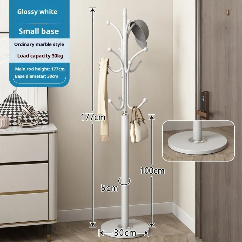 Floor-standing iron coat rack in black with vertical metal frame for hanging jackets and bags in a bedroom or hallway