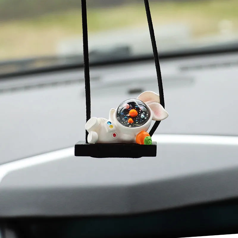 Resin astronaut car pendant in one of five cartoon colour designs