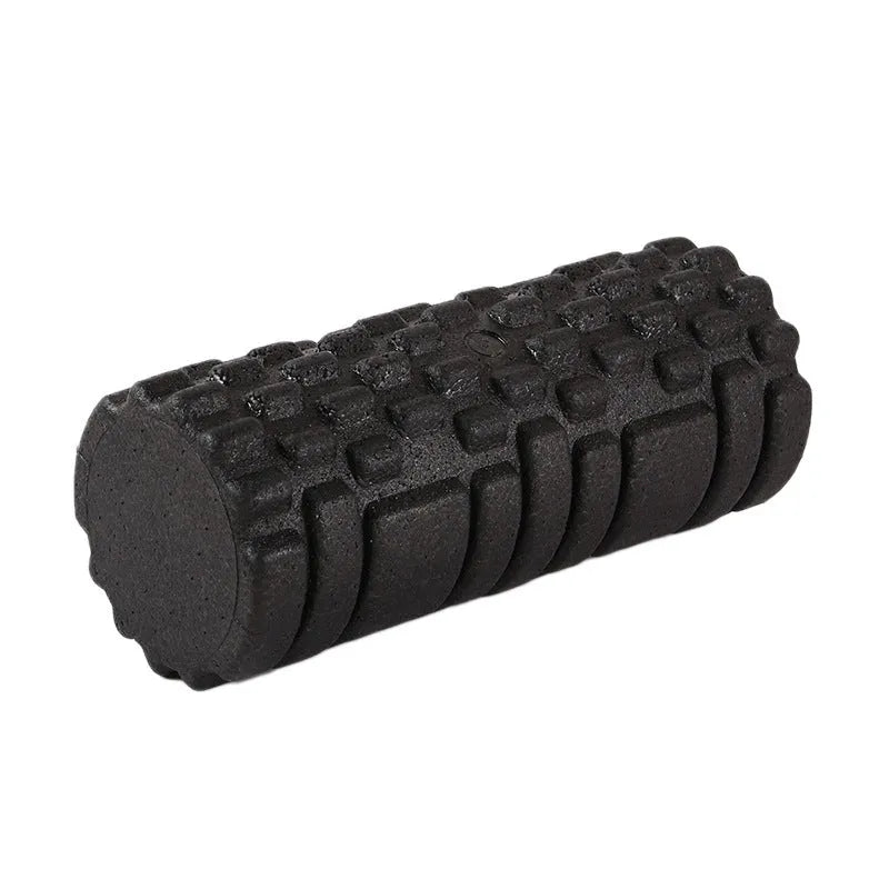 Hollow black EPP foam roller 33x14cm on flat surface for Pilates and balance exercises