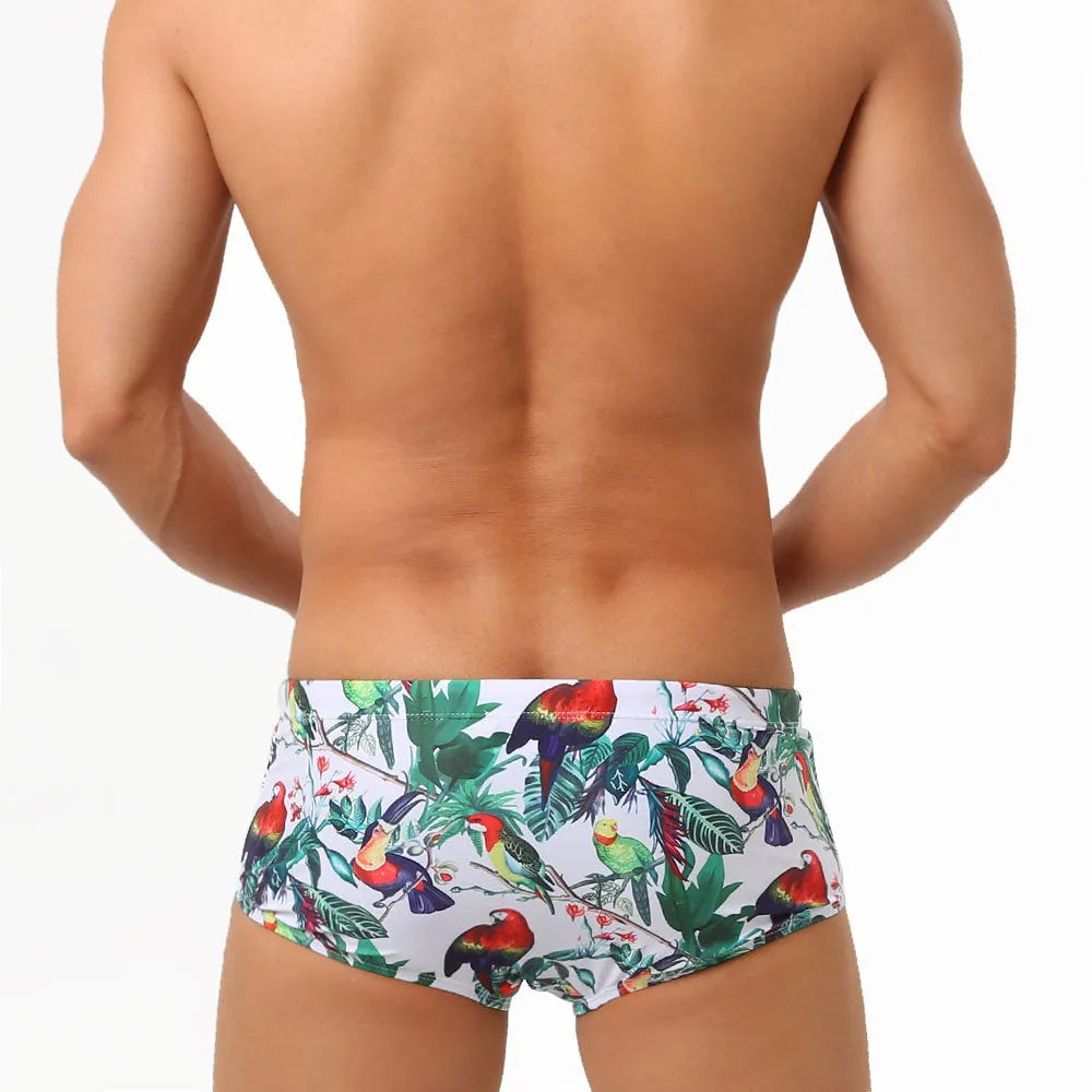 Men's navy swim trunks with white and red flower-bird print pattern, boxer briefs style