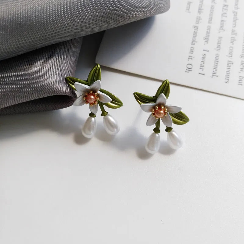 Women's alloy flower earrings with sterling silver needle camellia design and contrast colour styling