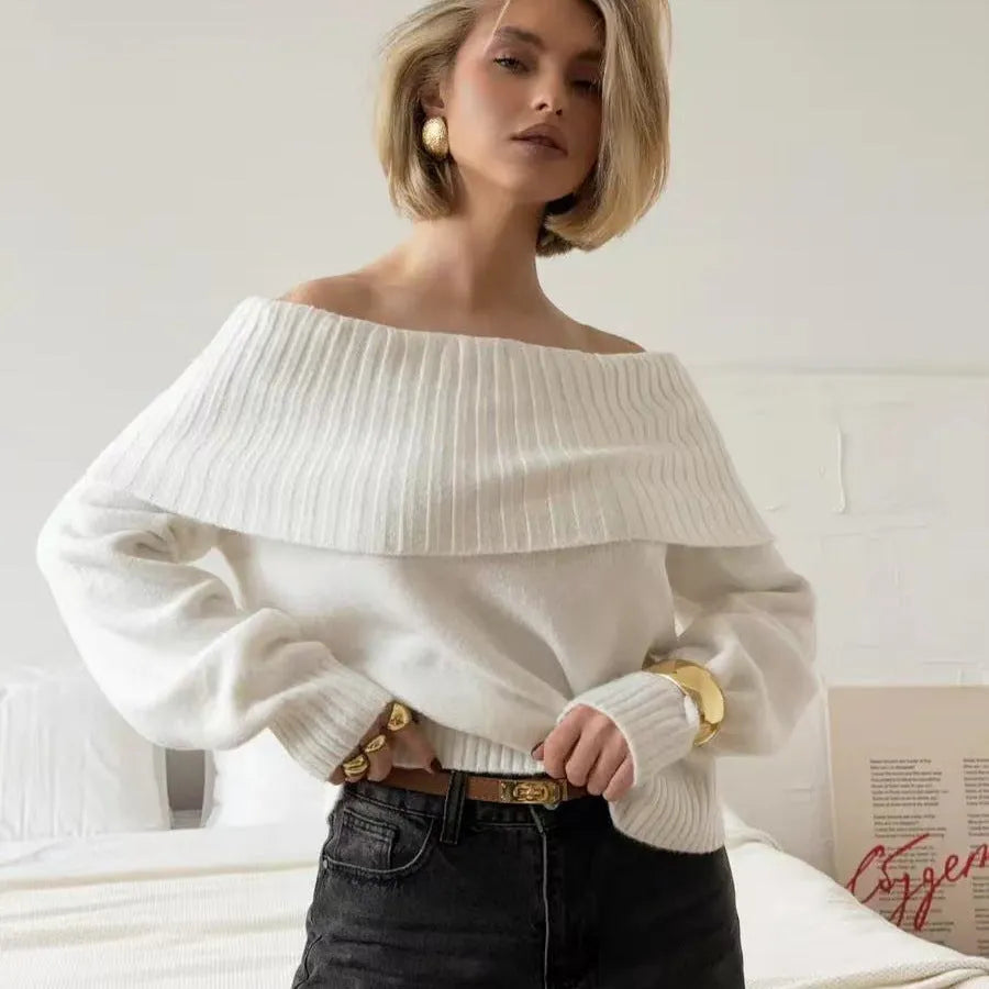 Grey off-the-shoulder strapless sweater with a 3D textured pattern and regular sleeves.